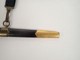a black and gold pen with a black strap on it