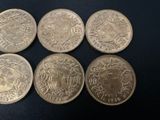 six different british coins are shown on a black surface