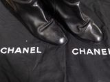 chanel boots on a black shirt with the word chanel written on it
