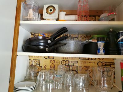 a shelf with many dishes and glasses on it