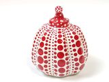 a red and white vase with a polka dot pattern on it