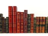 many books that are lined up on a shelf