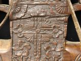 an old wooden bench with carvings on the back of it