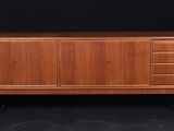 the sideboard is made of teak and has four drawers