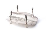 a silver plate with a handle on it on a white surface