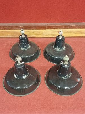 trois lampes noires posées sur un sol rouge