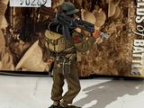 the figurine of a soldier with a machine gun stands in front of a box