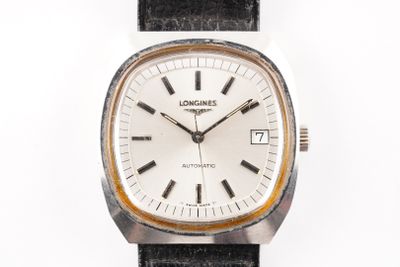 a close up of a watch on a white surface