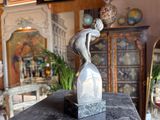 a statue of a bird sitting on top of a table