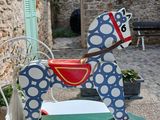 a toy horse that is sitting on top of a table