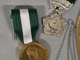 three medals and a medal are on display on a table