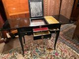 a small desk with a mirror on top of it