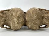 two pieces of stone sitting next to each other on a white surface