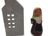 figurine of a woman with a house and a house