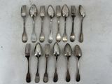 a lot of silver spoons and forks on a table