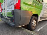 an image of a green and white van parked in a parking lot