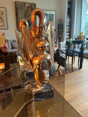 a glass table with a sculpture on it in a living room
