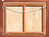 a picture of an old window with a rope hanging from it