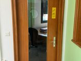 a wooden door with a mirror on the side of it