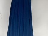 blue dress on a mannequin stand in front of a white wall
