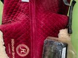 a red backpack with a fur lining and a cell phone in it
