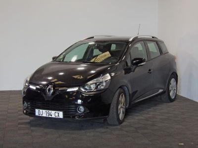 the small black car is parked in a room with a checkered floor