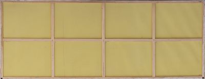 an old window with yellow panels and a wooden frame on the outside