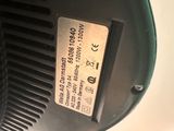 a close up of a black and white machine with a label on it