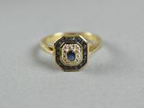 a close up of a gold ring with blue and white diamonds