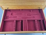 a wooden box that has a pair of scissors in it