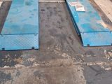 two blue steel plates sitting on top of a floor in a garage