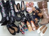 several pairs of women ' s shoes are lined up on a table