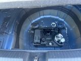 a close up of a car ' s trunk with the door open