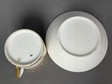 two white plates and a cup on a table