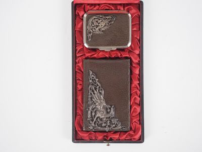 a silver and red box with a lighter and a lighter case