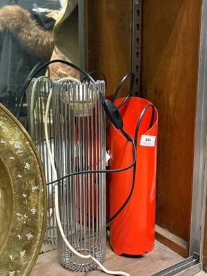 a red fire extinguisor sitting on a shelf next to a gold plate