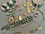 a lot of jewelry that is laying out on the table