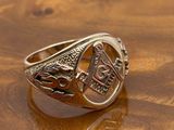 an image of a gold signet ring on a wooden surface