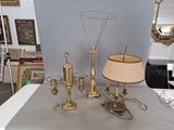 a table with a lamp, a lamp shade, and a mirror on it