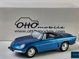 an old model of a blue sports car in front of a box