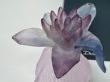 a glass vase with a flower in it on a table