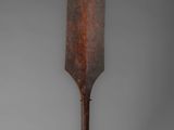 a close up of a wooden paddle on a metal stand