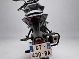 a motorcycle that is parked on a white surface