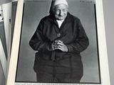 newspapers with a black and white photo of a man holding a camera
