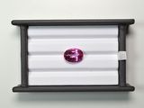 un gros plan sur un diamant rose dans un écrin noir