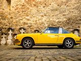 a yellow car that is parked in front of a building