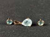 a close up of three pieces of jewelry on a black surface
