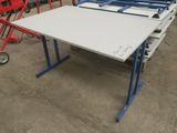 une table blanche sur laquelle repose un cadre bleu