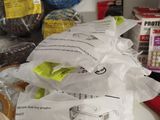 many bags of food sitting on a counter with scissors