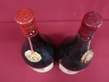 two bottles of wine that are sitting on a table